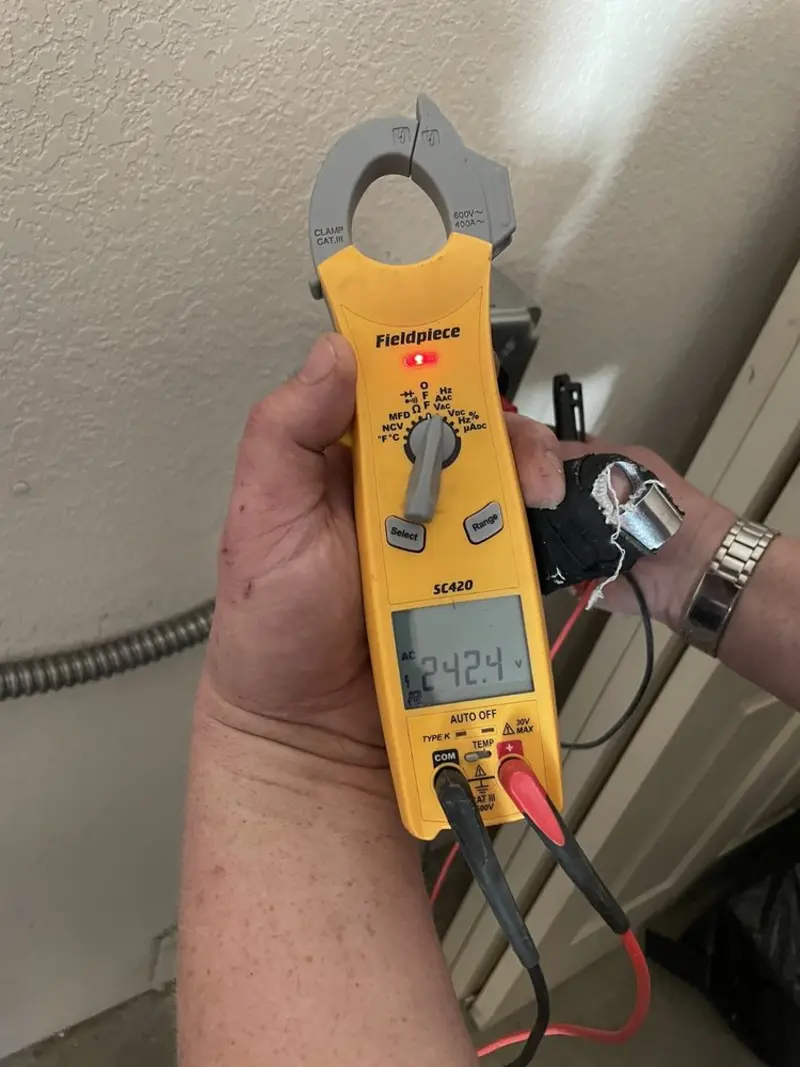 Voltage testing with clamp meter during Electrical Installation Services in Waterford